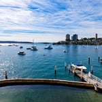 A large body of water with a city in the background