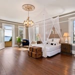 A view of a living room filled with furniture and a large window