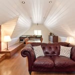 A brown leather couch in a living room