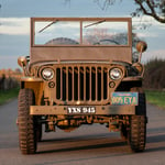 A truck driving down a dirt road