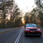 A close up of a car going down the road