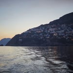 A large body of water with a mountain in the background