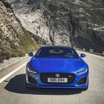 A blue car parked on the side of a mountain