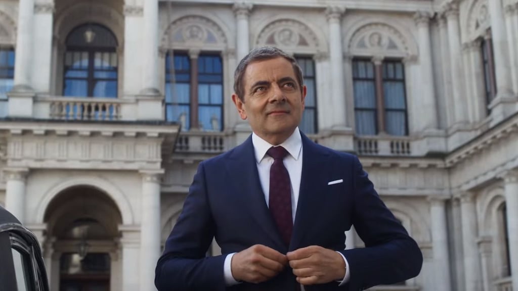 A man in a suit standing in front of a building