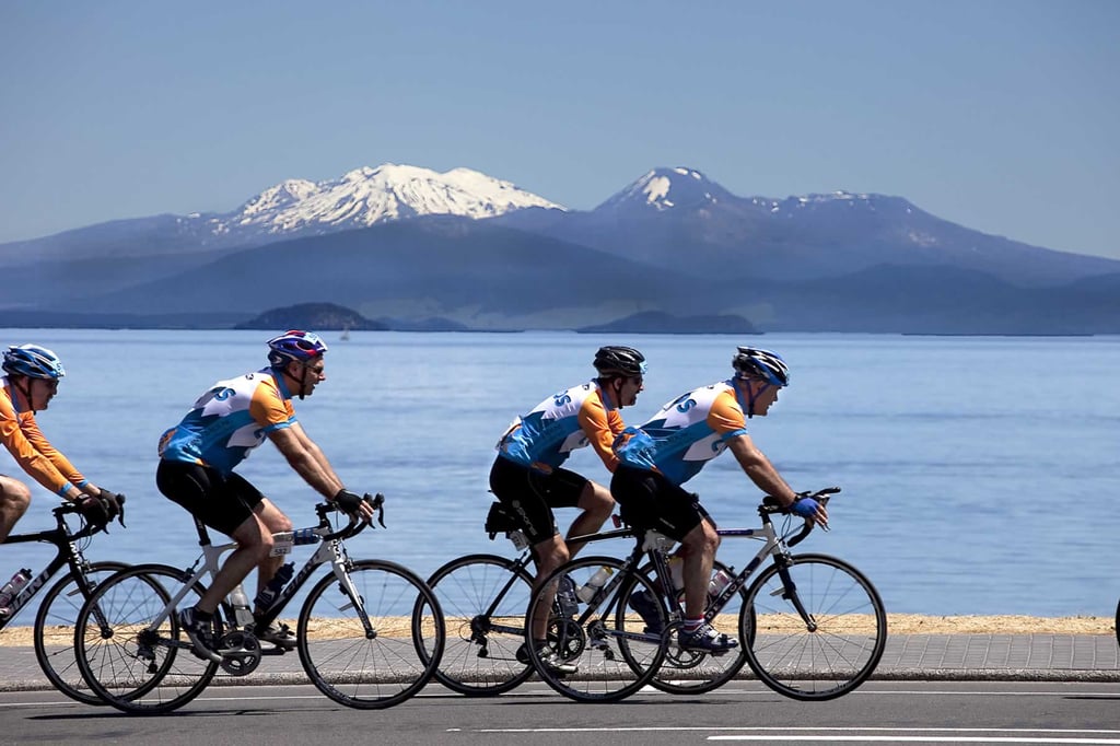 A group of people riding on the back of a bicycle