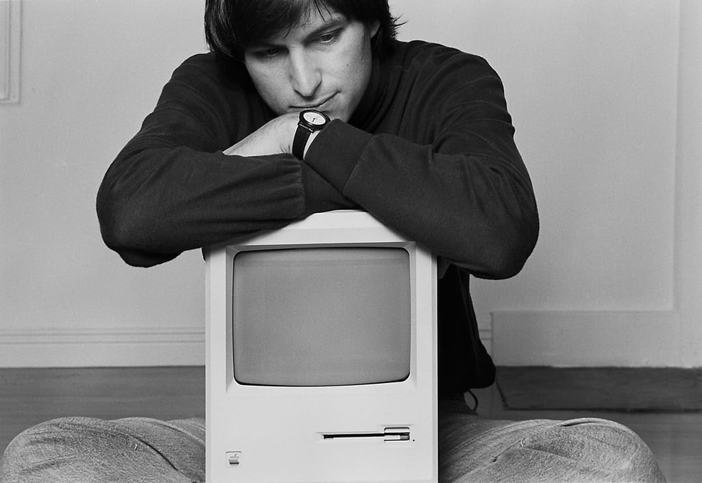 A man standing in front of a television