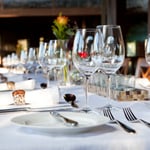 A dining table with wine glasses