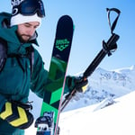 A man riding skis down a snow covered slope