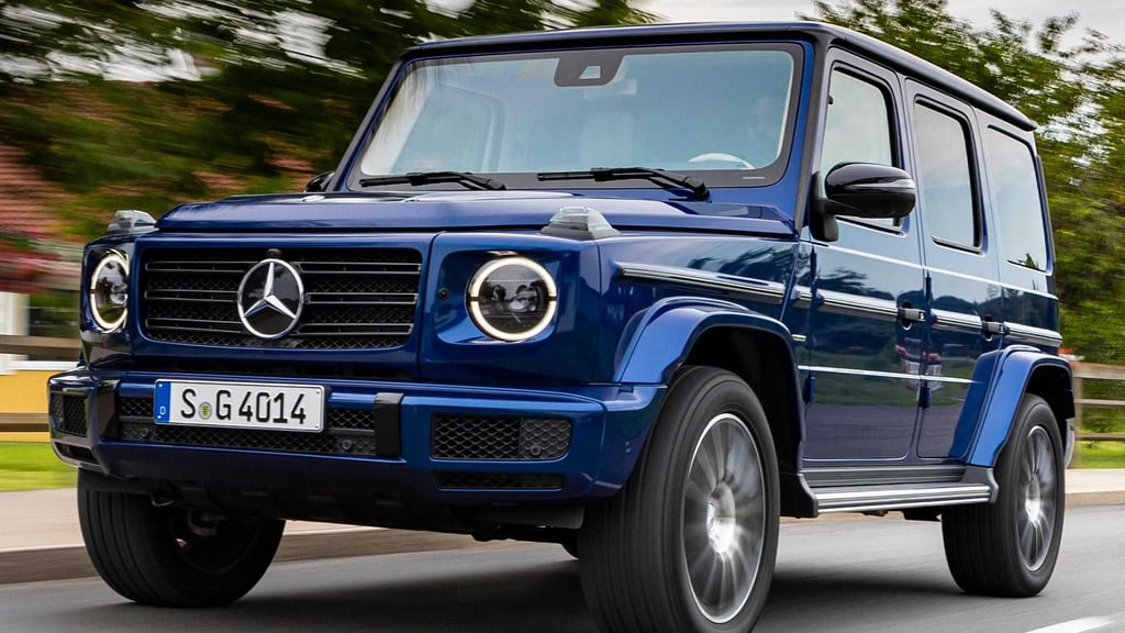 A truck is parked in front of a blue car