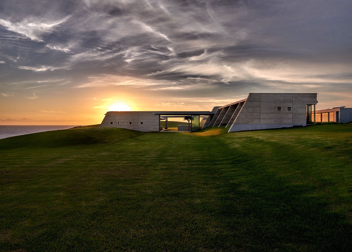 The home with the sunsetting behind. 