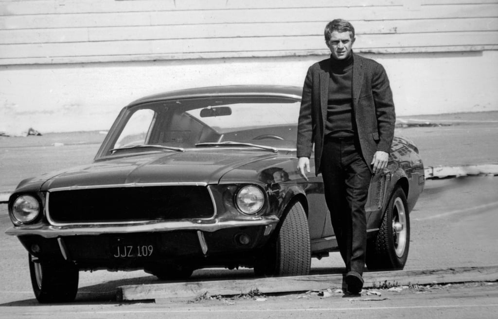 A man standing in front of a car