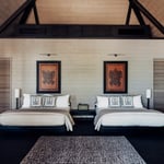 A bedroom with a bed and desk in a room