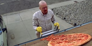 A man holding a pizza