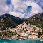 A large body of water with a mountain in the background