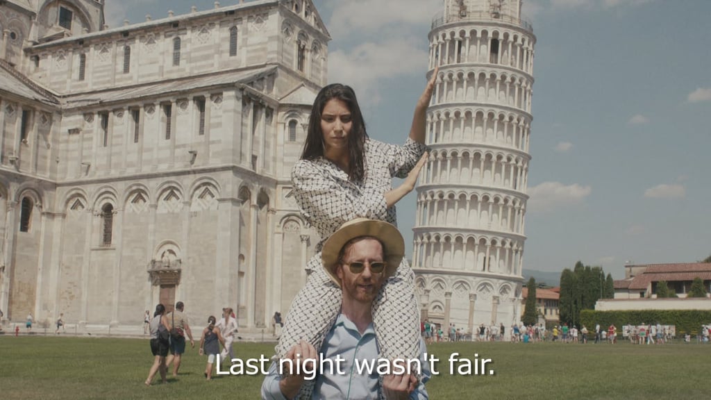 A person standing in front of Leaning Tower of Pisa