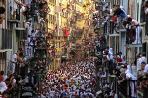 A large crowd of people walking down a street