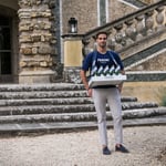 A person standing in front of a brick building