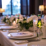 A person sitting at a table with wine glasses