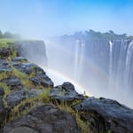 A large waterfall over a rocky cliff