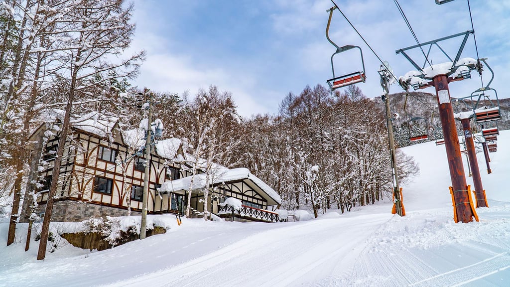 A man riding a snowboard down a snow covered slope