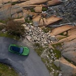 A close up of a stone building that has a rocky cliff