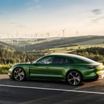 A green car parked on the side of a road