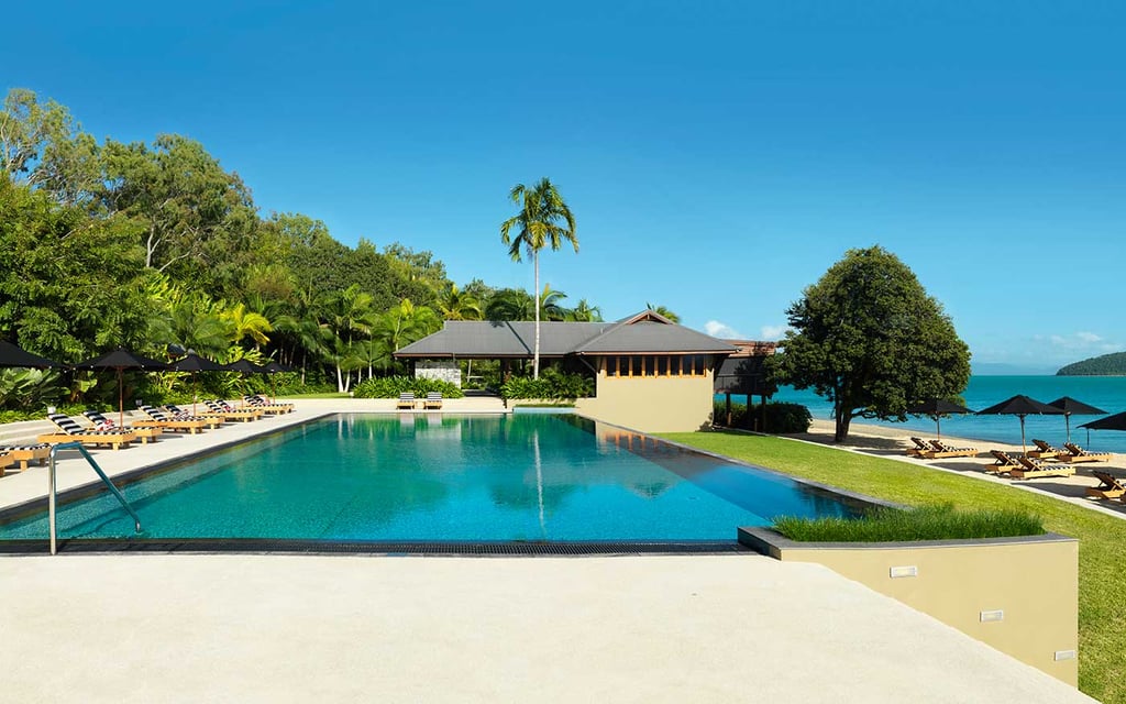 A pool next to a body of water