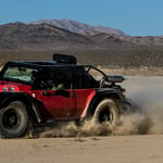 A truck driving down a dirt road