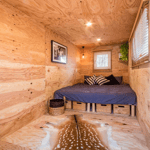 A bedroom with a wooden floor