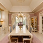 A room filled with furniture and vase of flowers on a kitchen counter