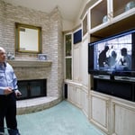 A person standing in front of a television