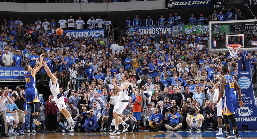 A group of basketball players in front of a crowd