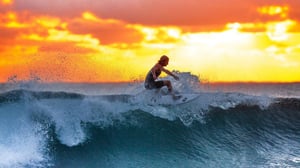 A man riding a wave on a surfboard in the water