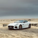 A car parked on a sandy beach