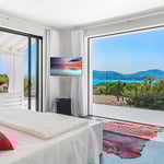 A bedroom with a bed and a large window