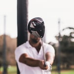 A man holding a baseball bat on a field