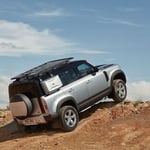 A car parked on the side of a dirt road