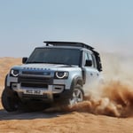 A truck driving down a dirt road