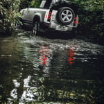 A car parked on the side of a river