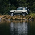 A truck is parked next to a body of water