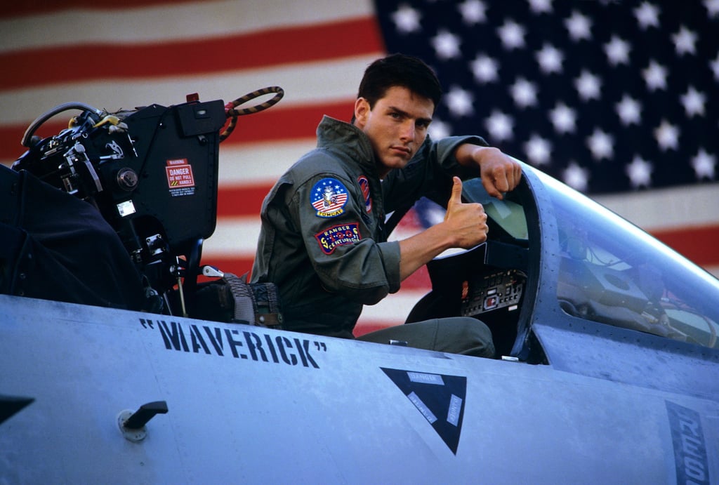 A man sitting in front of a plane