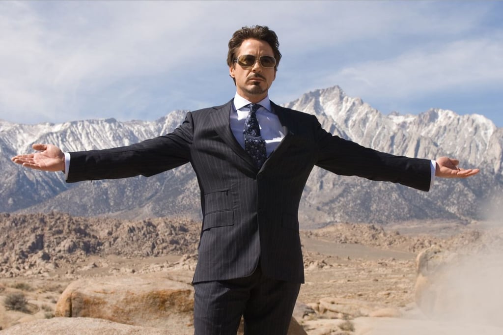A man in a suit with a mountain in the background