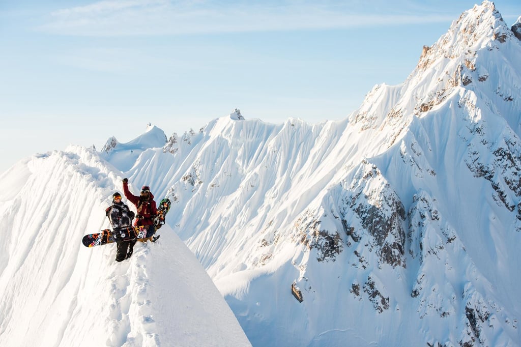 A man flying through the air on a snow covered mountain