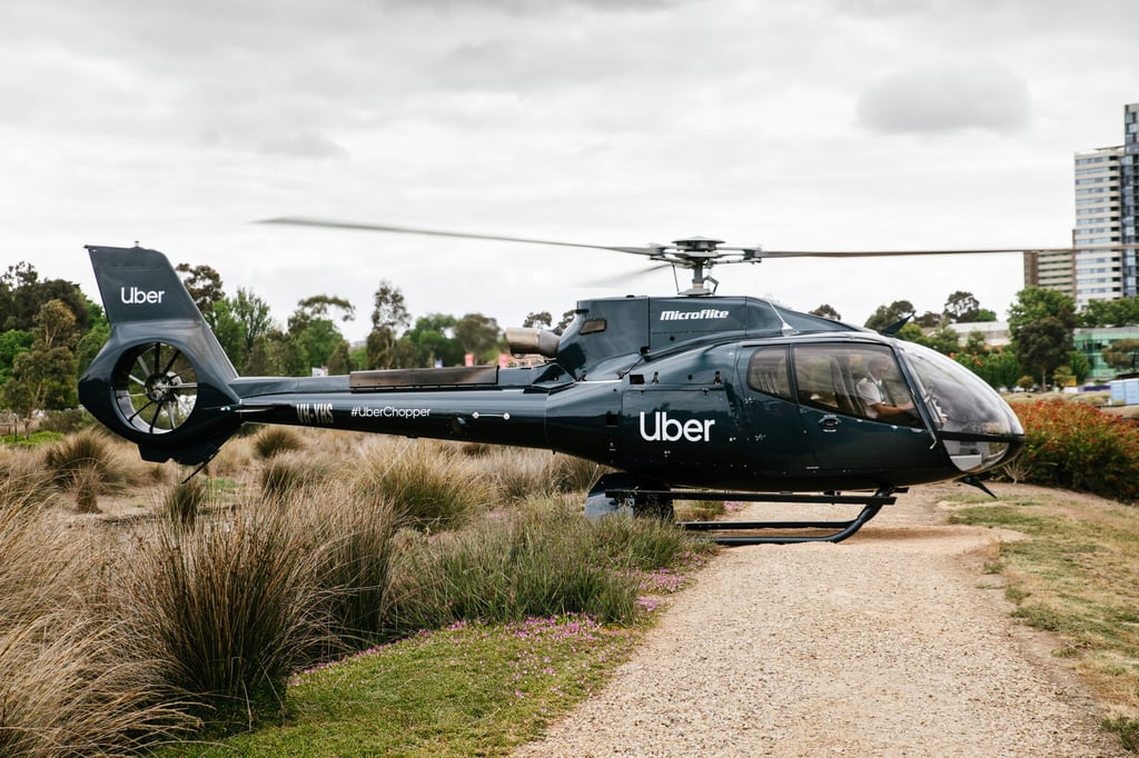 A helicopter parked on the side of a dirt road