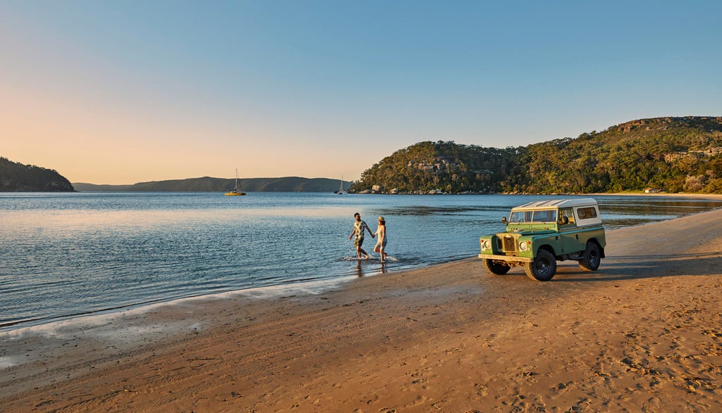 A couple of people on a beach near a body of water