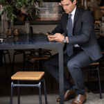 A man wearing a suit and tie sitting at a table