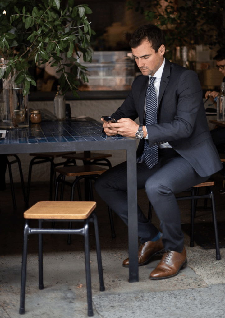 A man wearing a suit and tie sitting at a table