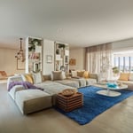 A bedroom with a bed and desk in a room