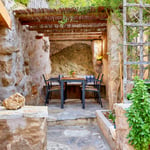 A stone bench sitting next to a fireplace