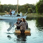 A man sitting in a boat on a body of water